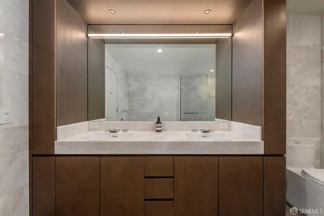 a bathroom with a double vanity sink and mirror