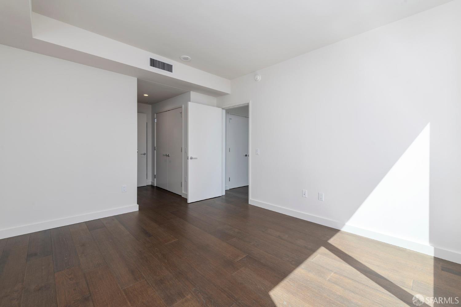 488 Folsom Street, Unit 4305 San Francisco, CA 94105 - Photo 19 of 45 an empty room with wooden floor