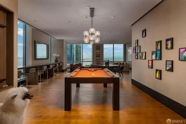 a living room with furniture and a floor to ceiling window