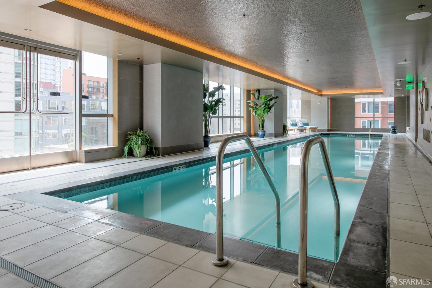 488 Folsom Street, Unit 4305 San Francisco, CA 94105 - Photo 39 of 45 a swimming pool with large glass windows and outdoor seating