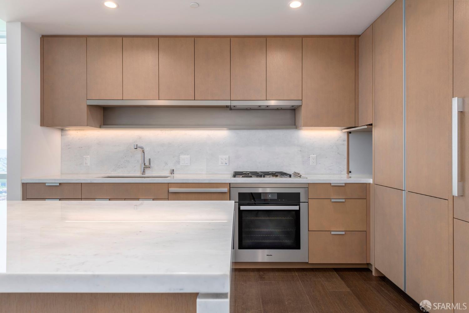 488 Folsom Street, Unit 4305 San Francisco, CA 94105 - Photo 4 of 45 a kitchen with stainless steel appliances granite countertop a stove a microwave and a refrigerator