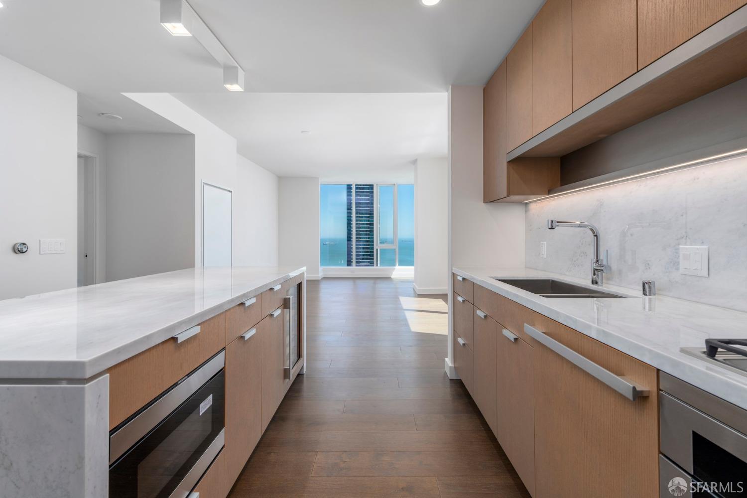 488 Folsom Street, Unit 4305 San Francisco, CA 94105 - Photo 5 of 45 a large kitchen with stainless steel appliances a sink stove and cabinets