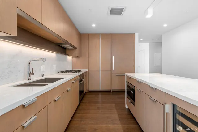 a kitchen with a sink stove and cabinets