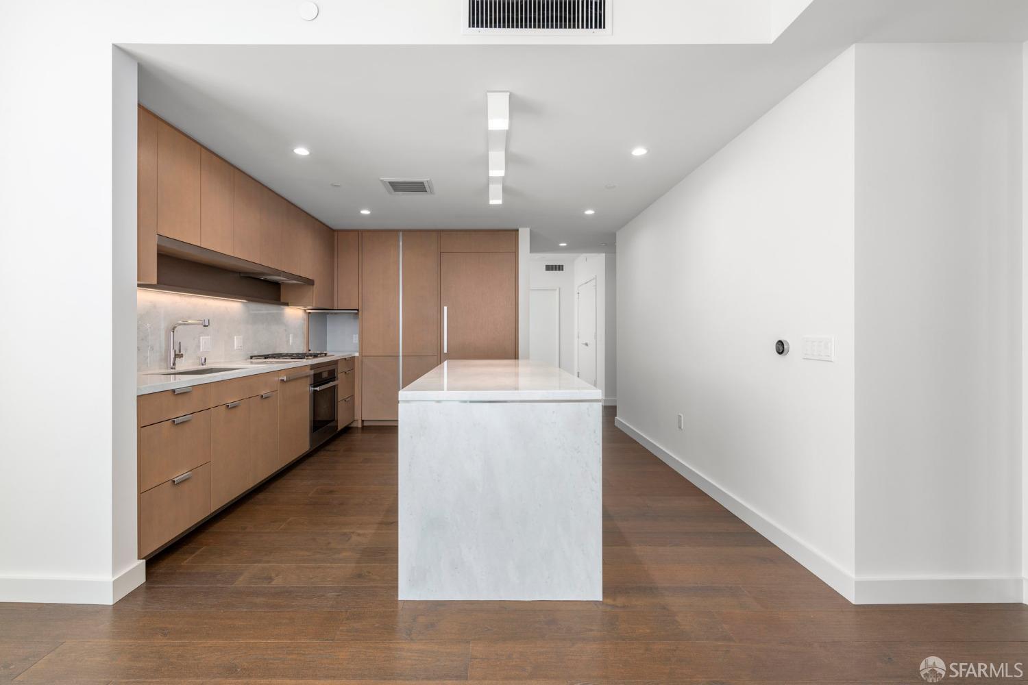 488 Folsom Street, Unit 4305 San Francisco, CA 94105 - Photo 7 of 45 a large kitchen with a large counter top a sink stainless steel appliances and cabinets
