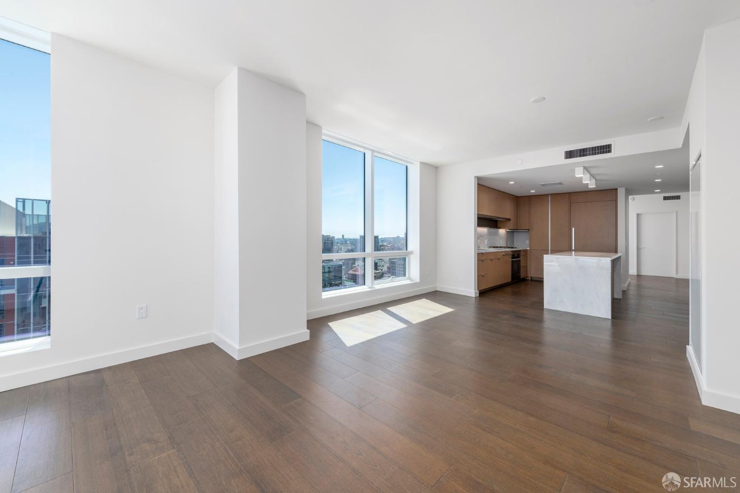 488 Folsom Street, Unit 4305 San Francisco, CA 94105 - Photo 8 of 45 a view of an empty room with wooden floor and a window