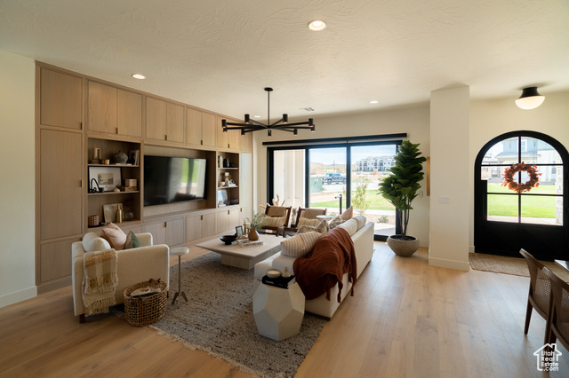 5366 Cyan Lane St. George, UT 84790 - Photo 4 of 39 Living room featuring light wood-style flooring, recessed lighting, a chandelier, and a textured ceiling
