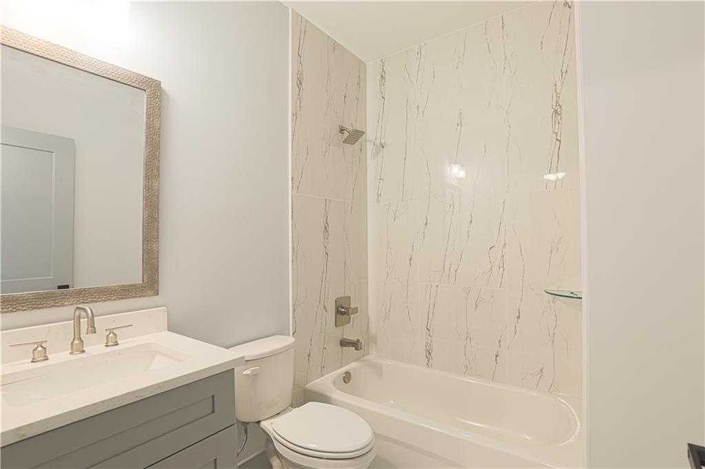 1341 Wheeler Creek Road Maysville, GA 30558 - Photo 34 of 51 a bathroom with a bathtub shower sink vanity and toilet