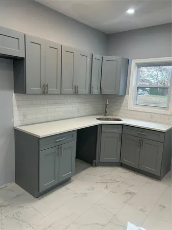 a kitchen with stainless steel appliances granite countertop a sink and cabinets