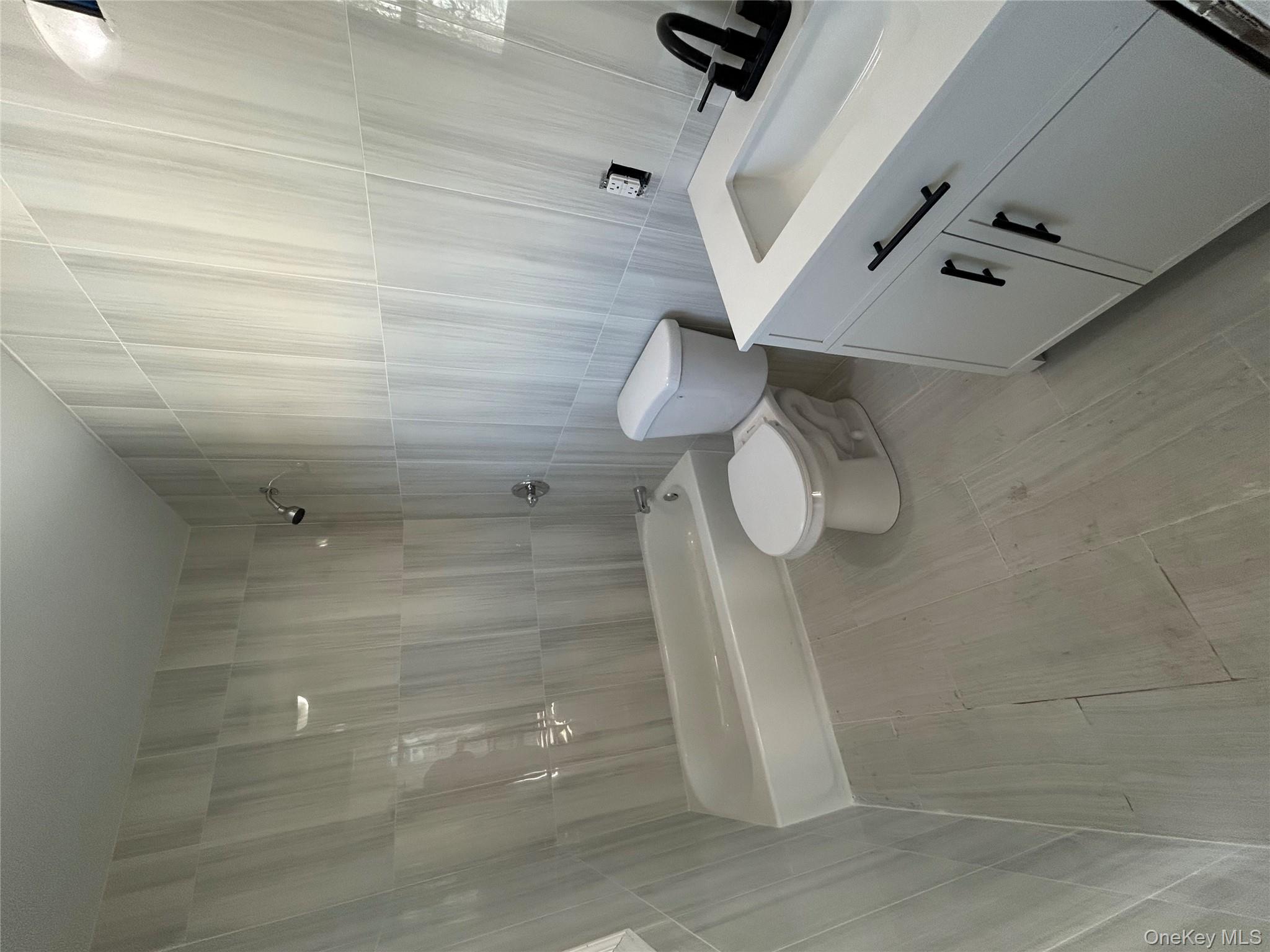 562 South 9th Avenue Mount Vernon, NY 10550 - Photo 2 of 8 a bathroom with a sink a toilet and shower