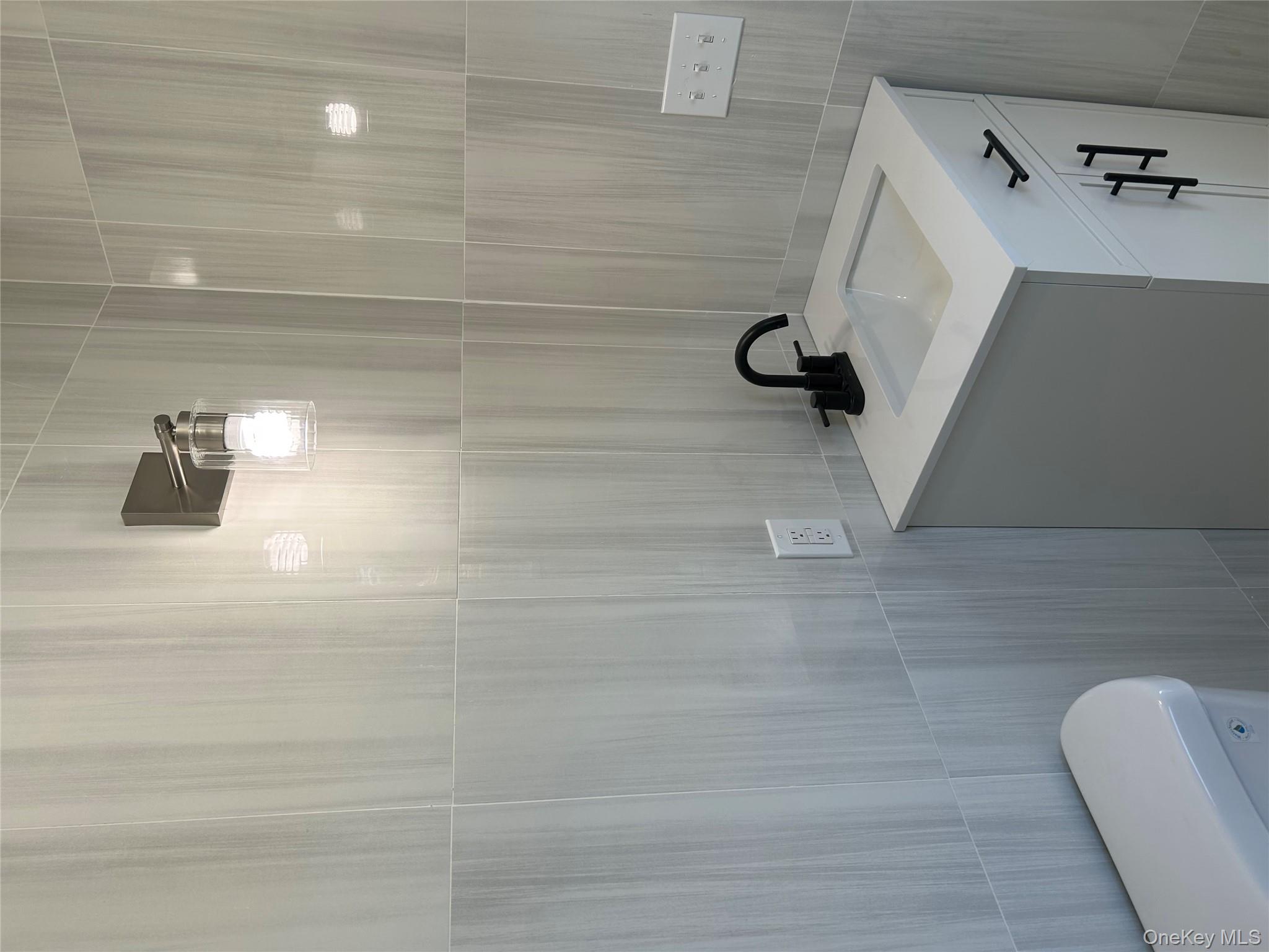 562 South 9th Avenue Mount Vernon, NY 10550 - Photo 3 of 8 a bathroom with a sink a toilet and shower