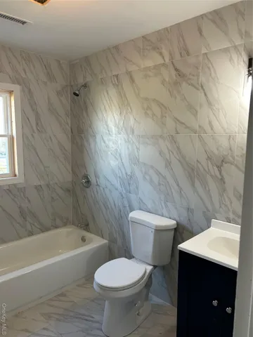 a bathroom with a toilet a sink and bathtub