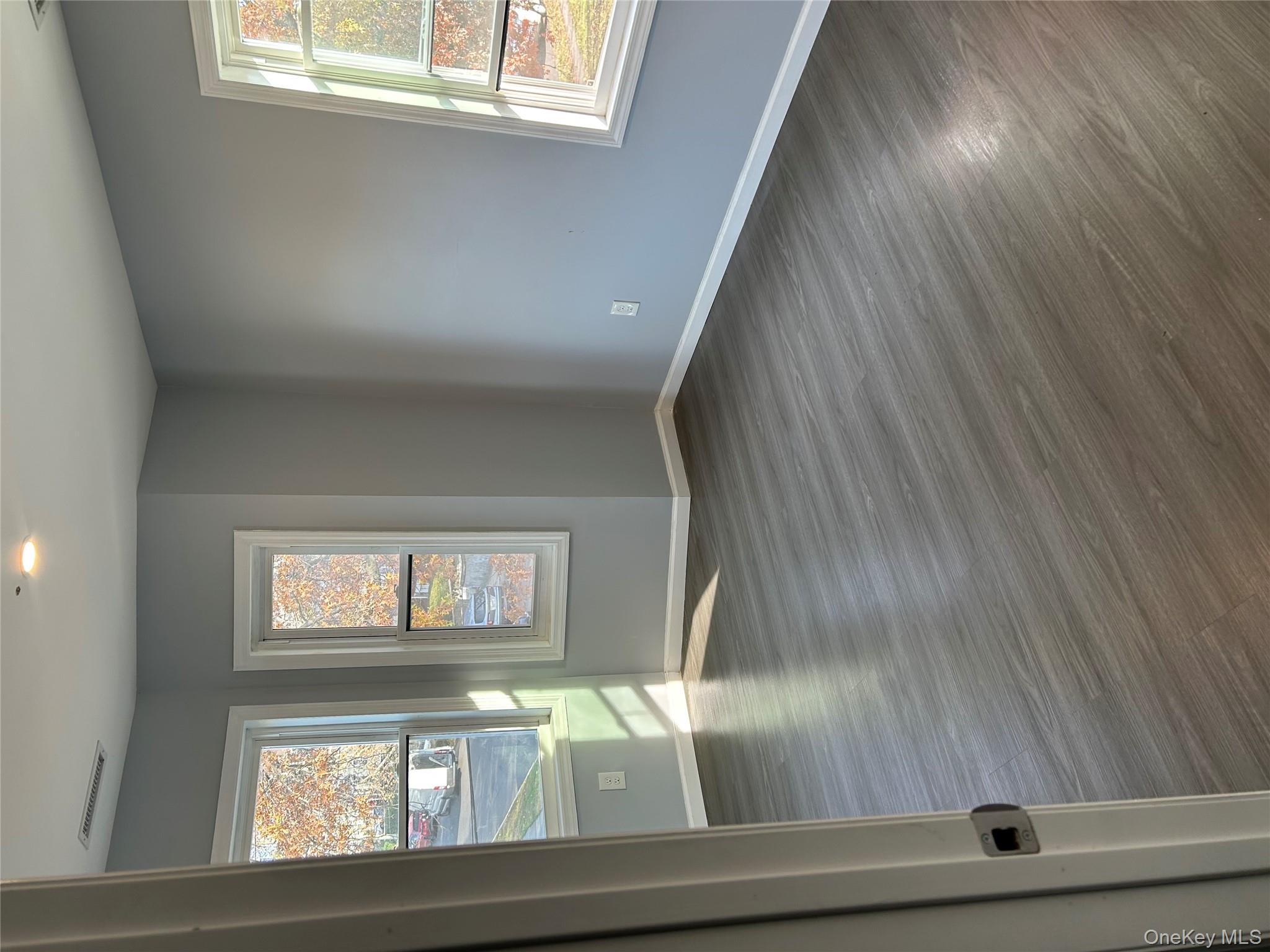 562 South 9th Avenue Mount Vernon, NY 10550 - Photo 5 of 8 an empty room with wooden floor and windows