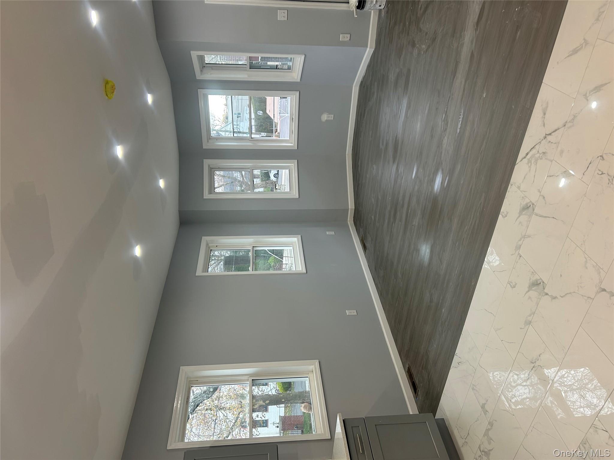 562 South 9th Avenue Mount Vernon, NY 10550 - Photo 6 of 8 a view of an empty room with wooden floor and a window