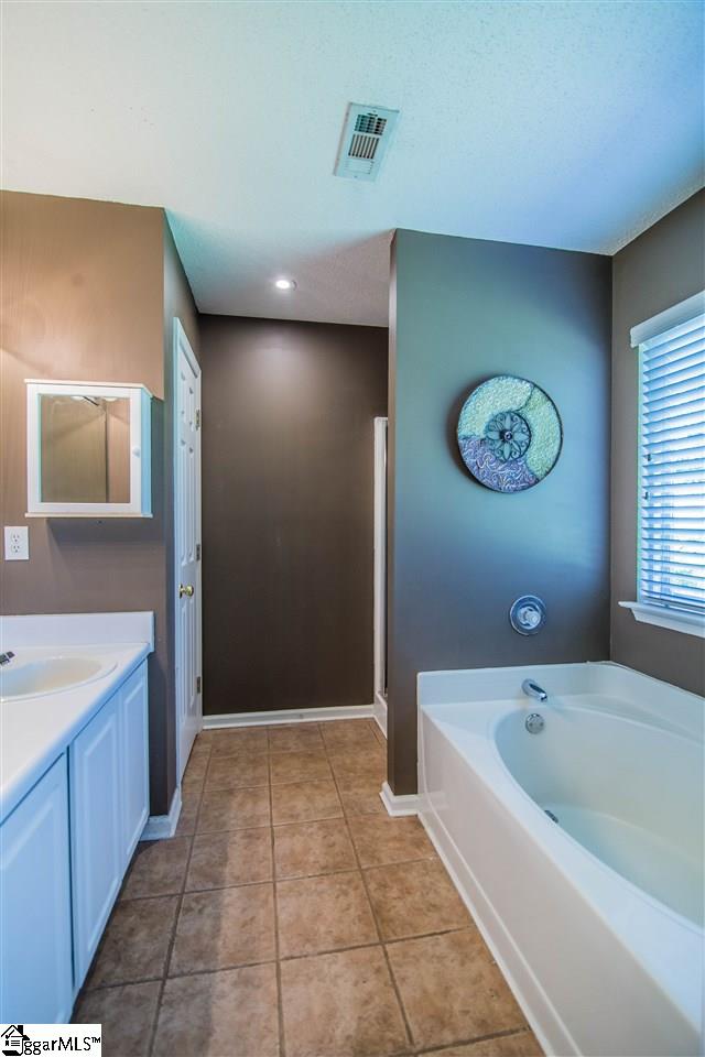 303 Woolridge Way Greer, SC 29650 - Photo 17 of 33 Owners Suite Bathroom, Double Vanity, Ceramic Tile Flooring, Linen Closet, Garden Tub, Shower with Glass Door