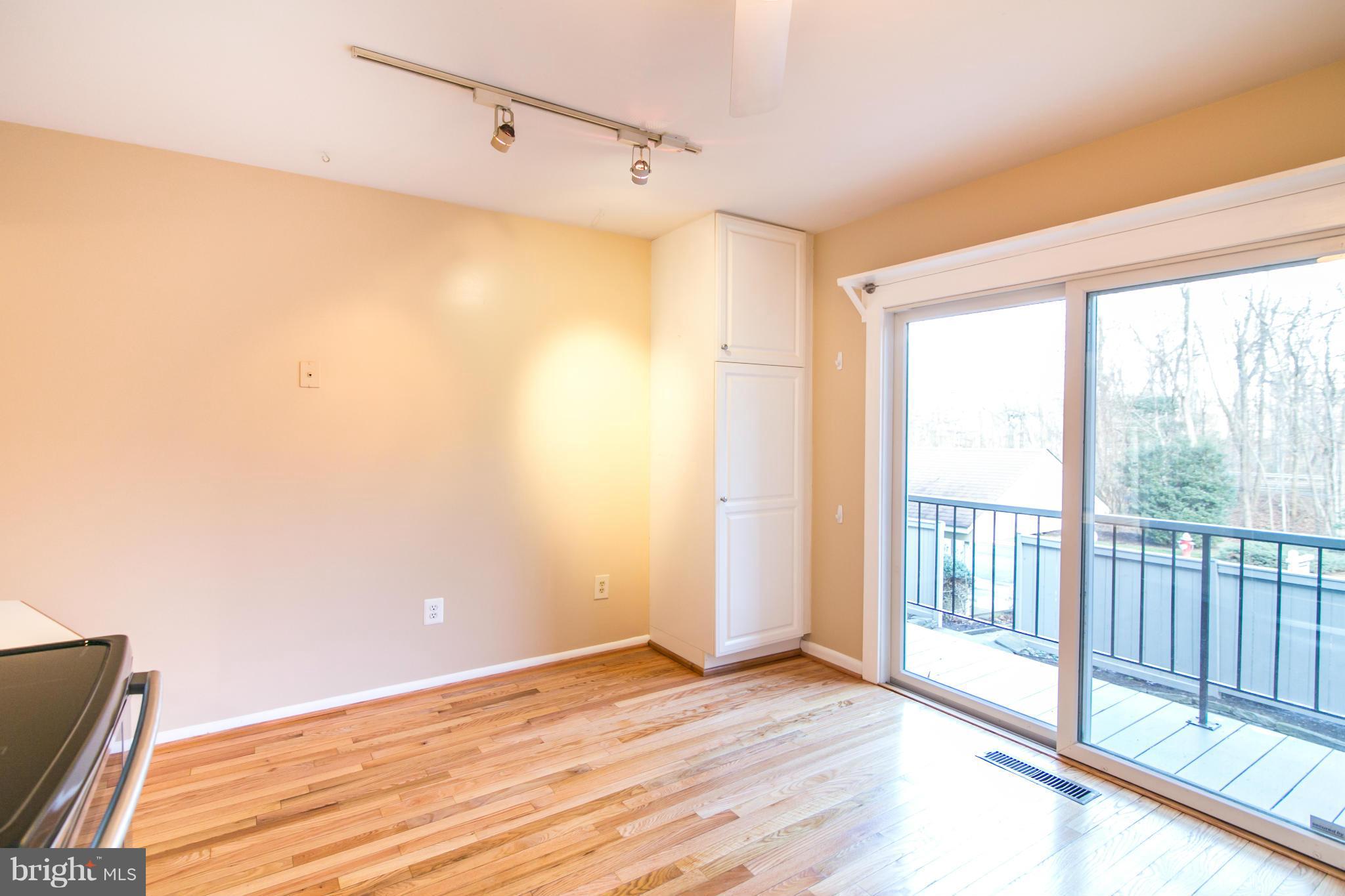 12017 Insha Court Reston, VA 20191 - Photo 14 of 30 The kitchen has hardwoods and leads to the balcony