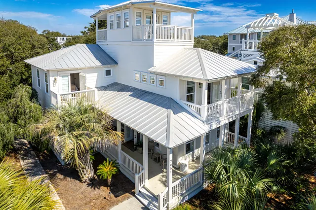 a front view of a house with a yard and balcony