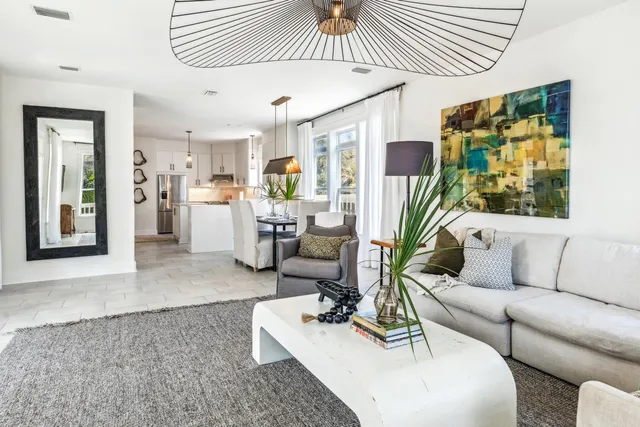 a view of a dining room with furniture wooden floor and a potted plant