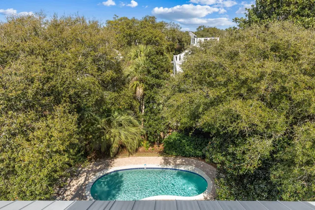 a view of a roof deck with wooden floor and city view