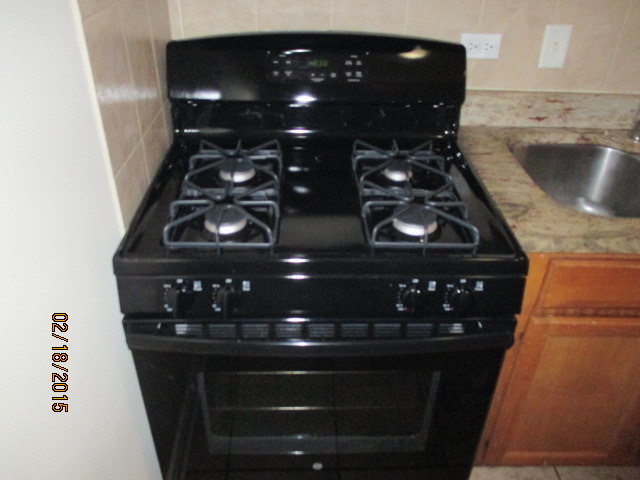 6001 Marshall Avenue, Unit 4 Chicago Ridge, IL 60415 - Photo 4 of 7 a close up of a stove top oven sitting inside of a kitchen