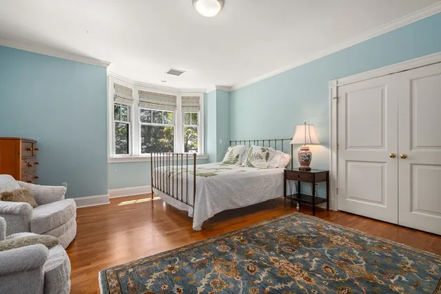 a bedroom with furniture and wooden floor