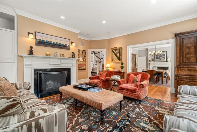 a living room with furniture fireplace and window