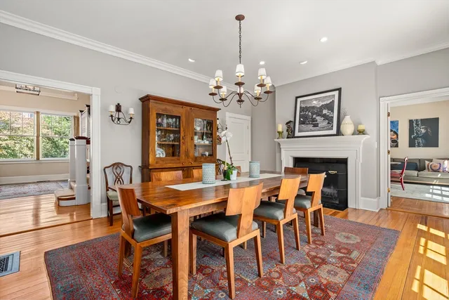 a dining room with furniture a chandelier and wooden floor