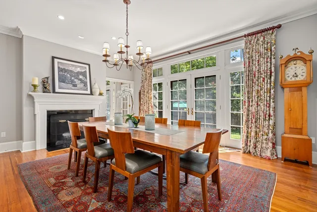 a dining room with furniture a chandelier and wooden floor
