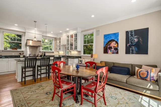 a living room with furniture and kitchen view