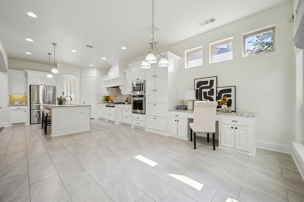 2029 Temperate Drive Allen, TX 75013 - Photo 11 of 40 a view of a kitchen with kitchen island stainless steel appliances refrigerator a sink dishwasher with a dining table and chairs