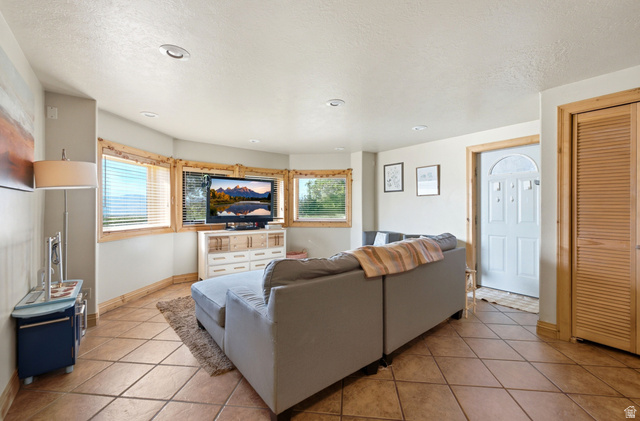 335 Bern Way Midway, UT 84049 - Photo 61 of 88 Living area featuring neutral-toned tile flooring, light-colored walls, and a white ceiling with recessed lighting