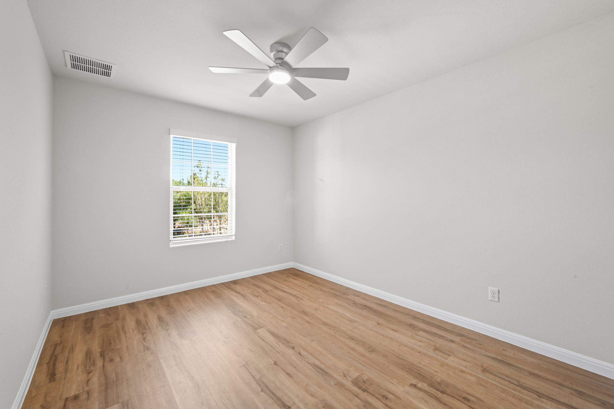 351 Wincliff Drive Buda, TX 78610 - Photo 28 of 40 A well-lit bedroom features durable hardwood flooring and a refreshing ceiling fan for comfort.