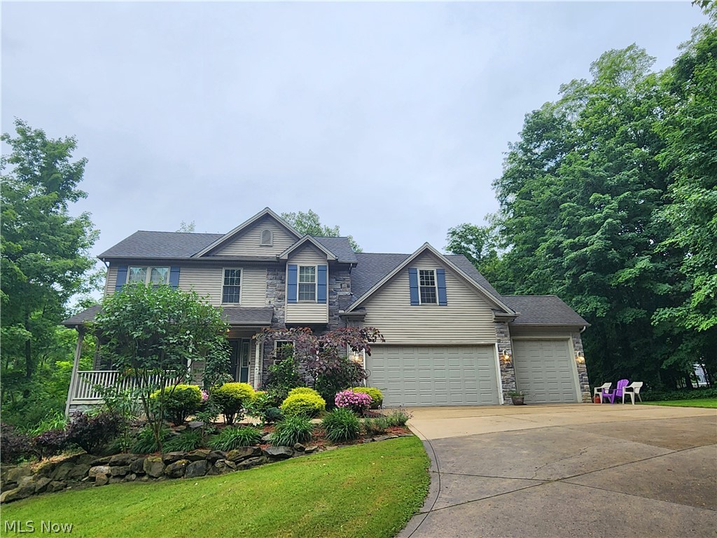 Craftsman-style home featuring a garage and a front yard
