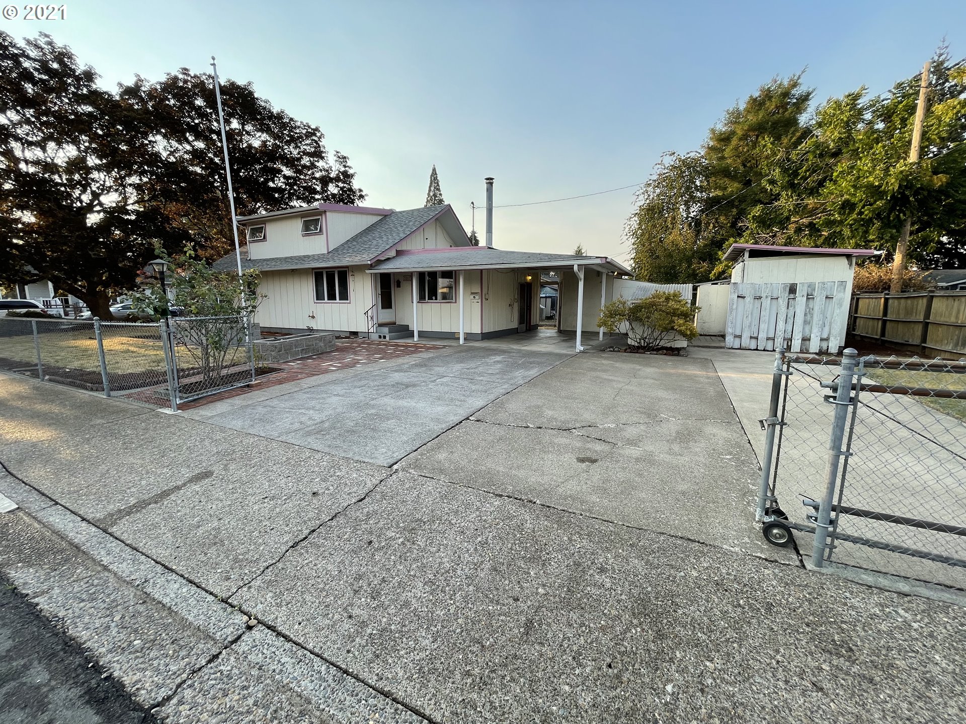 2002 H Street Springfield, OR 97477 - Photo 1 of 17 a front view of a house with a garden