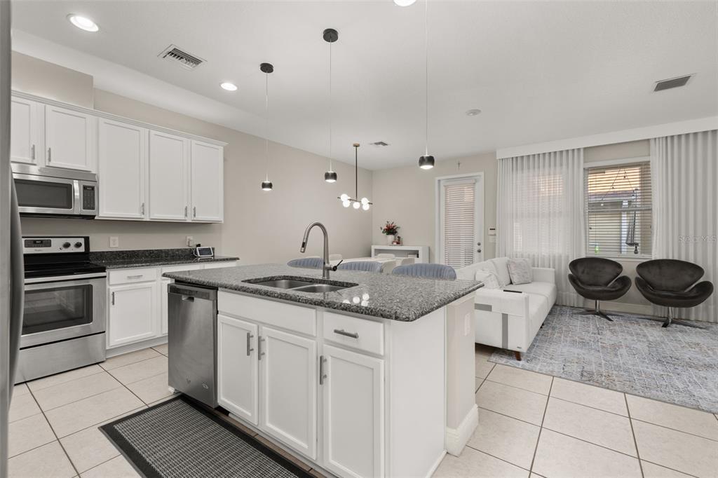 12333 Via Derna Place Windermere, FL 34786 - Photo 15 of 56 a kitchen with a sink stove and cabinets