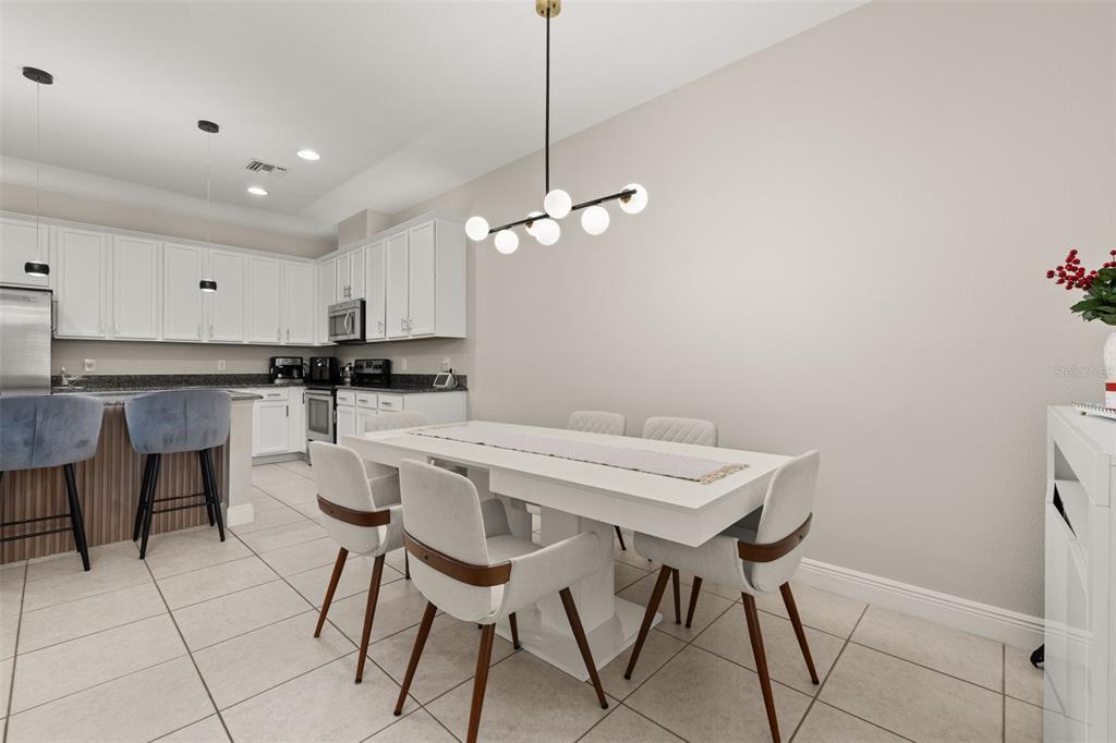 12333 Via Derna Place Windermere, FL 34786 - Photo 19 of 56 a kitchen with a dining table chairs and cabinets