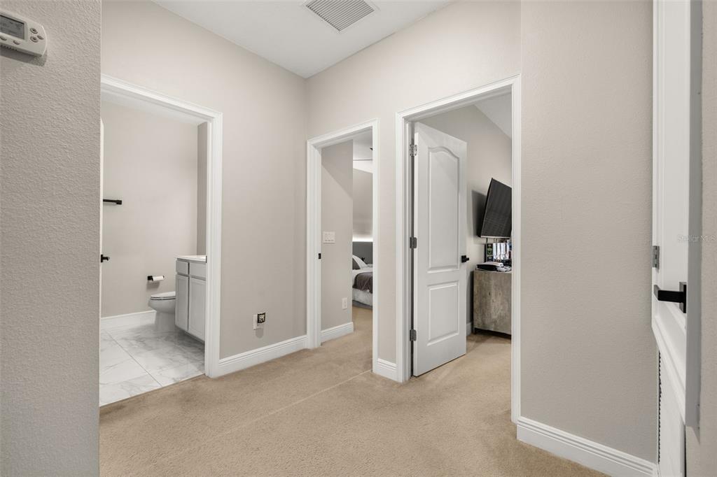 12333 Via Derna Place Windermere, FL 34786 - Photo 23 of 56 a view of a bathroom with a walk in closet and wooden floor