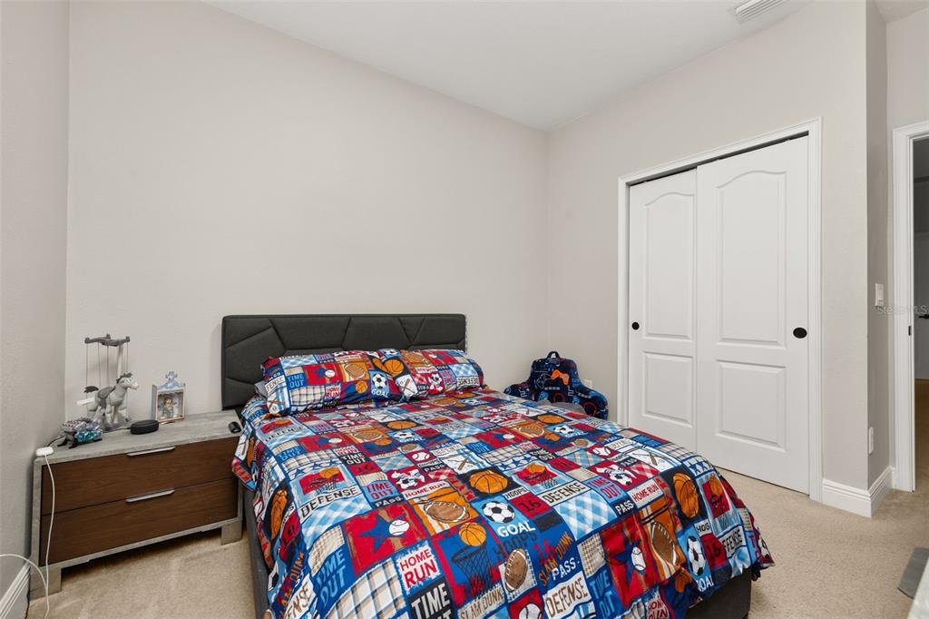 12333 Via Derna Place Windermere, FL 34786 - Photo 25 of 56 a bedroom with a bed and a dresser in it