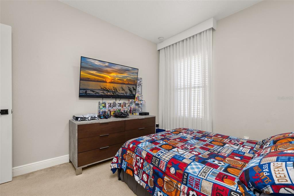 12333 Via Derna Place Windermere, FL 34786 - Photo 26 of 56 a bedroom with a bed and a flat screen tv