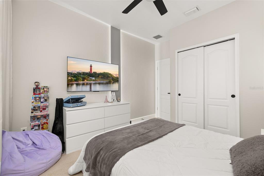 12333 Via Derna Place Windermere, FL 34786 - Photo 29 of 56 a bedroom with a bed and a book shelf