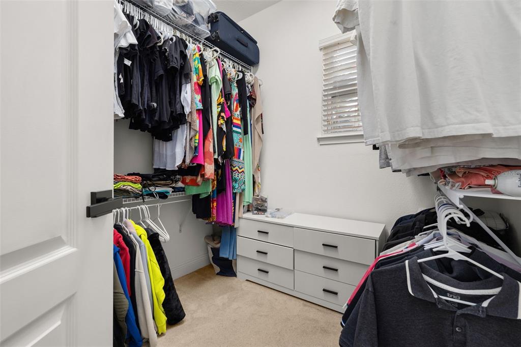 12333 Via Derna Place Windermere, FL 34786 - Photo 34 of 56 a view of walk in closet with clothes and shoes