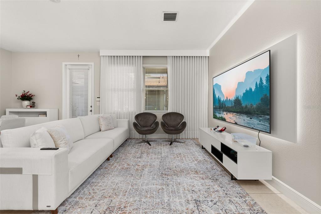 12333 Via Derna Place Windermere, FL 34786 - Photo 9 of 56 a living room with furniture and a flat screen tv