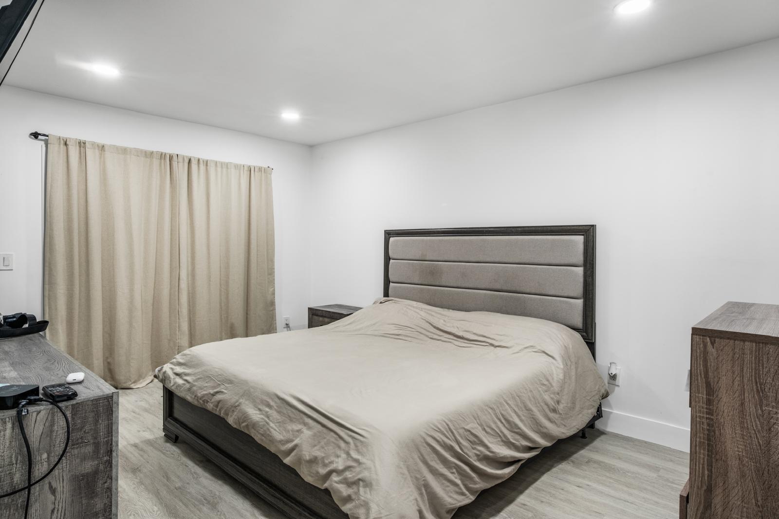 23284 Southwest 53rd Avenue, Unit D Boca Raton, FL 33433 - Photo 20 of 22 a bedroom with a bed and a mirror