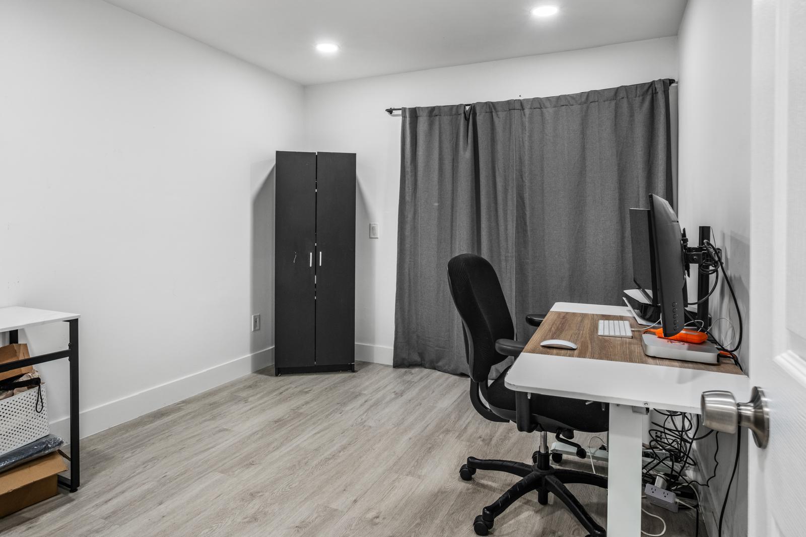 23284 Southwest 53rd Avenue, Unit D Boca Raton, FL 33433 - Photo 21 of 22 a view of a workspace with furniture and wooden floor