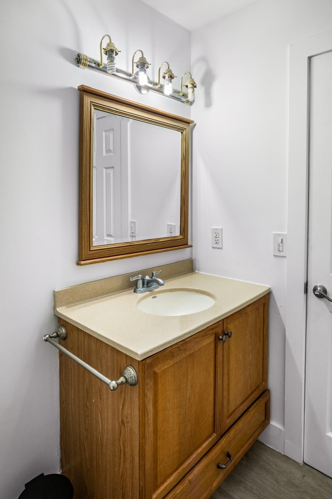 23284 Southwest 53rd Avenue, Unit D Boca Raton, FL 33433 - Photo 22 of 22 a bathroom with a sink and a mirror