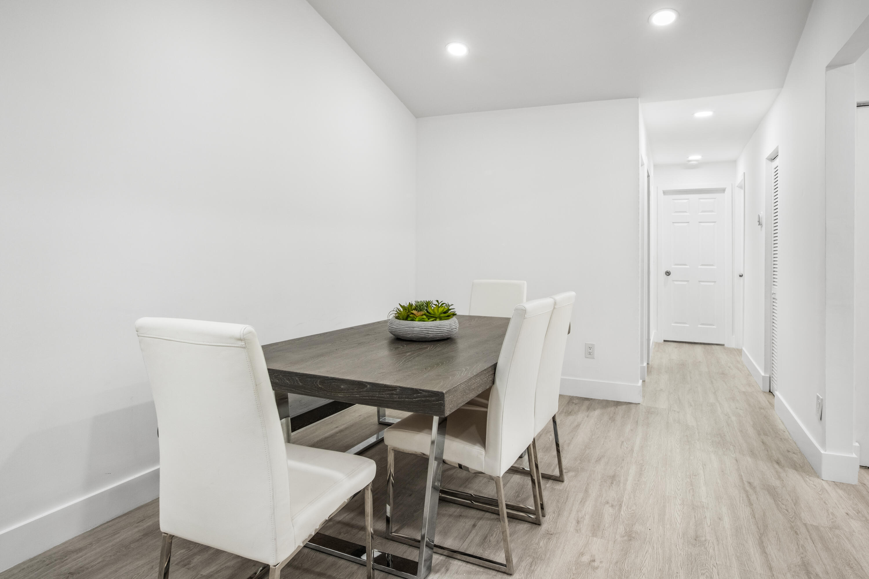 23284 Southwest 53rd Avenue, Unit D Boca Raton, FL 33433 - Photo 3 of 22 a view of a workspace with furniture and wooden floor