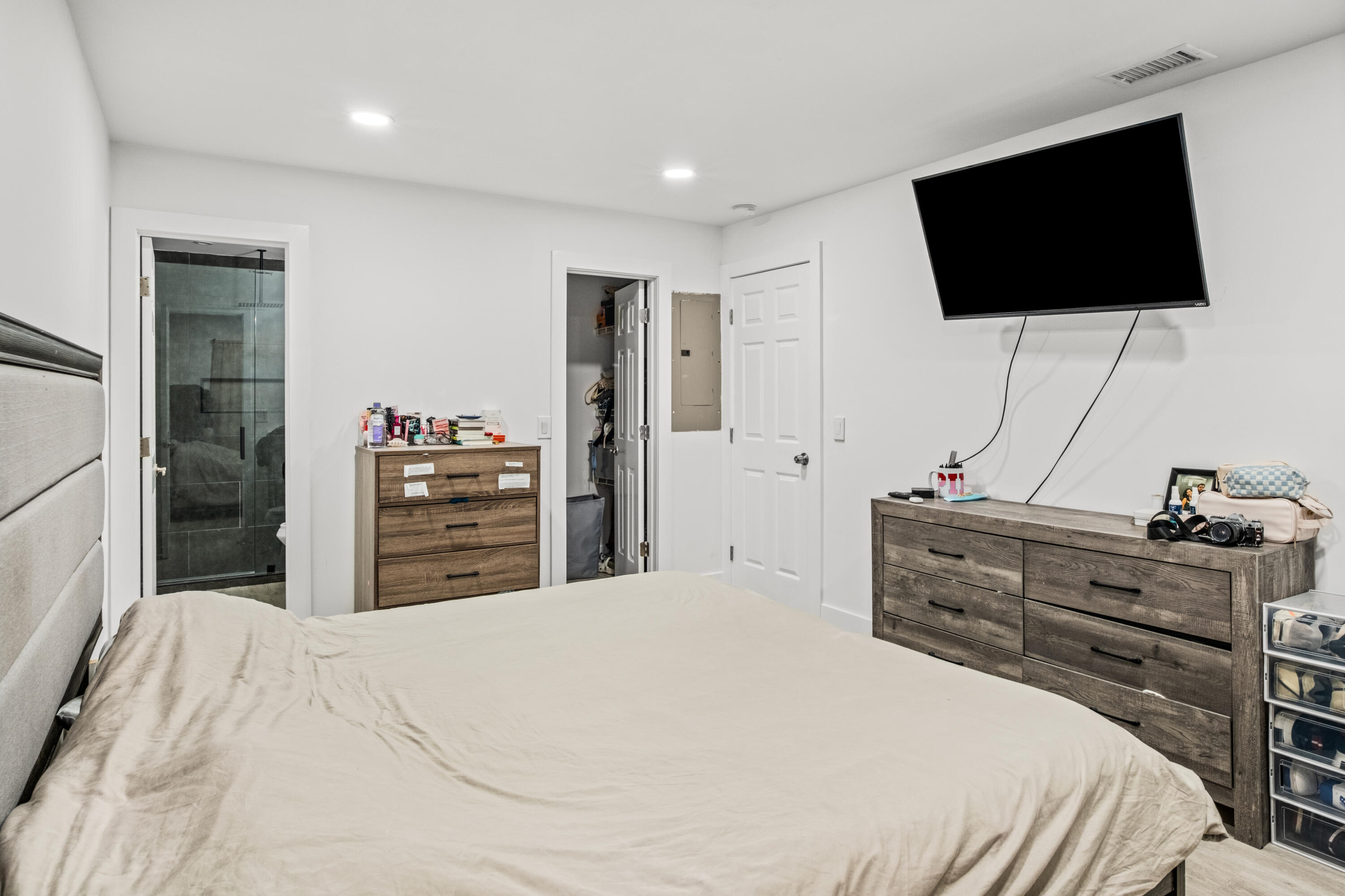 23284 Southwest 53rd Avenue, Unit D Boca Raton, FL 33433 - Photo 4 of 22 a bedroom with a bed and a flat screen tv