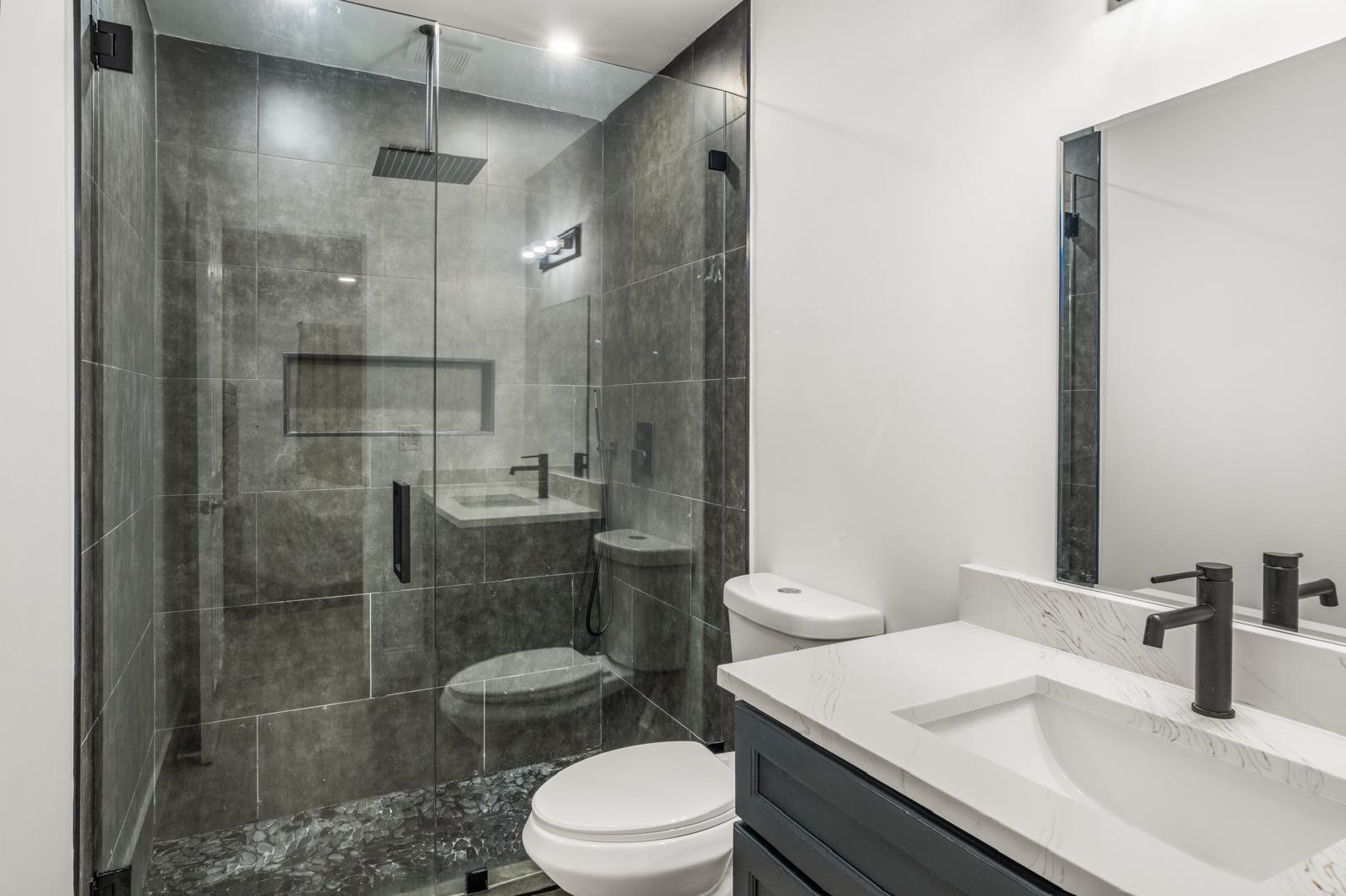 23284 Southwest 53rd Avenue, Unit D Boca Raton, FL 33433 - Photo 5 of 22 a bathroom with a sink a toilet and shower