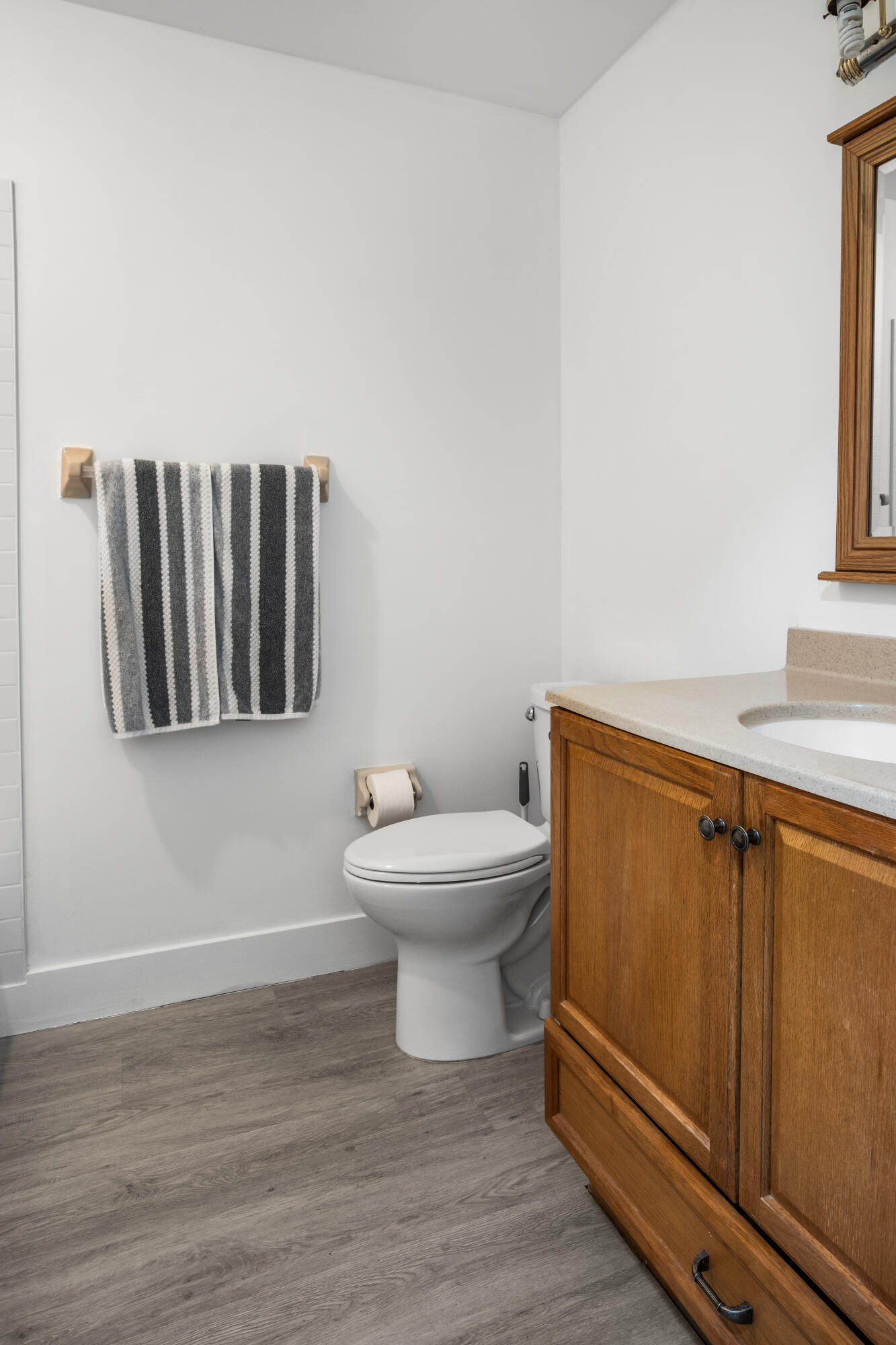 23284 Southwest 53rd Avenue, Unit D Boca Raton, FL 33433 - Photo 7 of 22 a bathroom with a toilet a sink and mirror