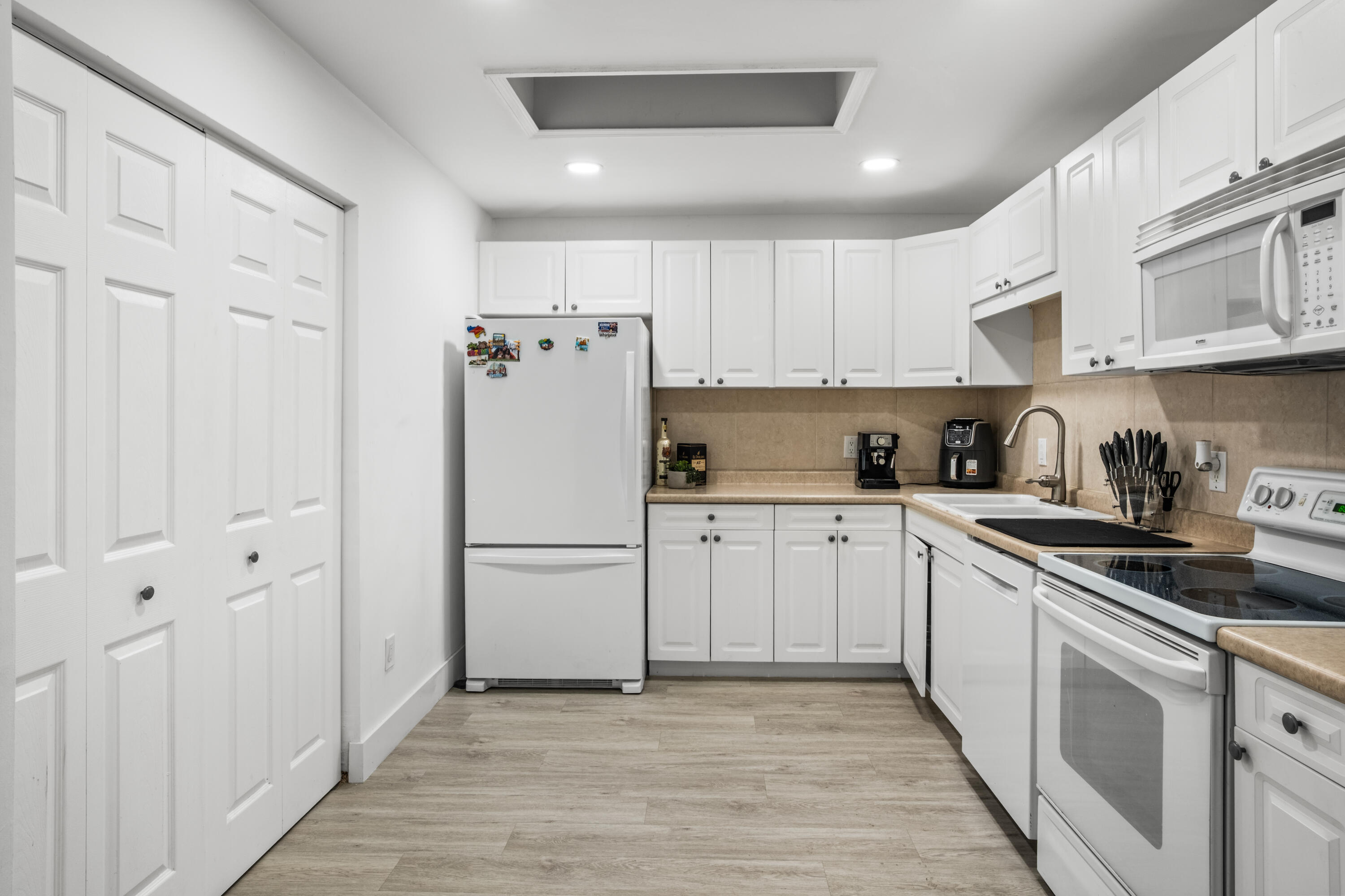 23284 Southwest 53rd Avenue, Unit D Boca Raton, FL 33433 - Photo 9 of 22 a kitchen with cabinets a refrigerator and a sink