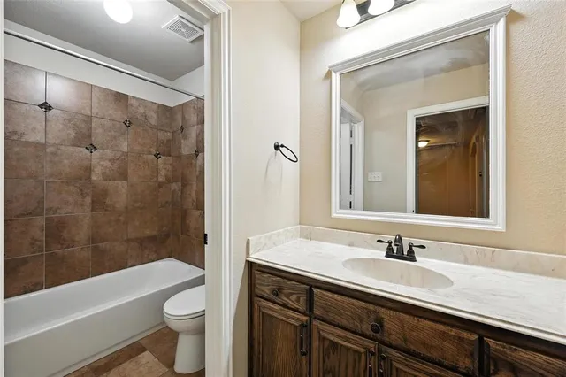 a bathroom with a sink a toilet a bathtub and shower